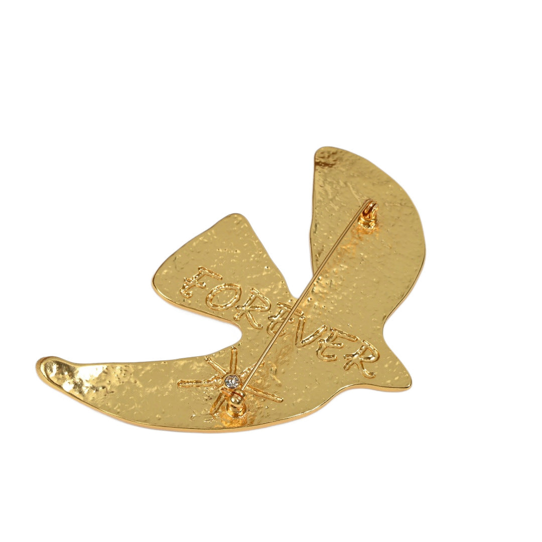 Back detail of Golden Echoes peace dove brooch showing craftsmanship and brooch pin, 18K gold plated brass jewelry