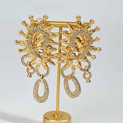 Vintage Sun God crystal stud earrings studio shot on grey background, 18K gold plated surrealist jewelry

