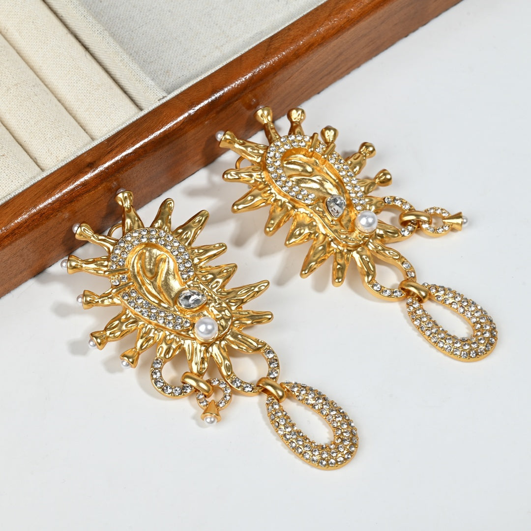 Close-up detail of Vintage Sun God earring showing crystal inlays and gold sun motif, styled product shot