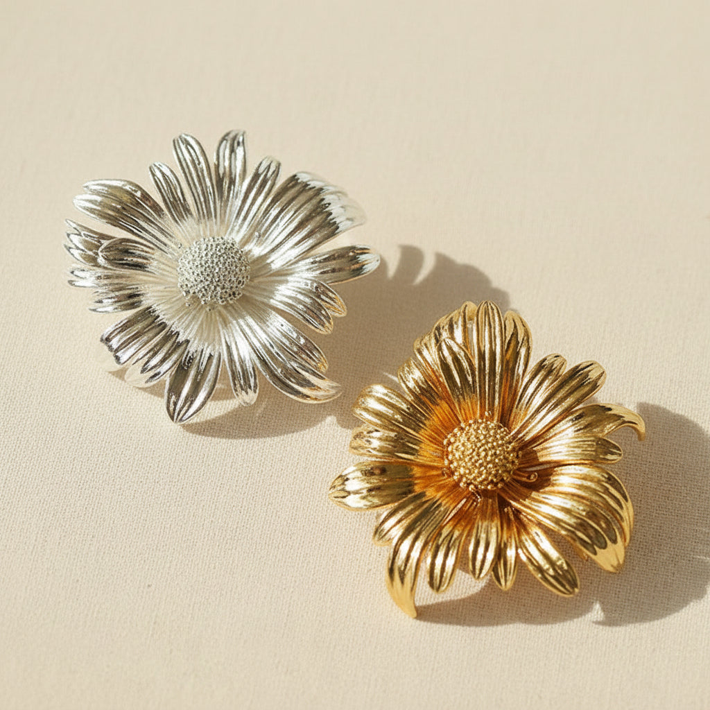 Top view of the sculptural flower brooches in both silver and gold color options, ideal for vintage-inspired styling.
