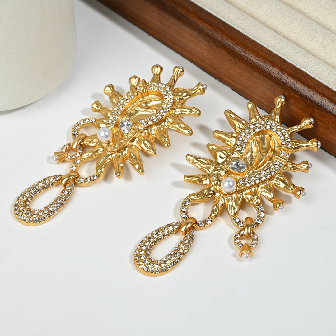 Vintage Sun God 18K gold stud earrings styled detail shot highlighting sunburst design and crystal embellishments