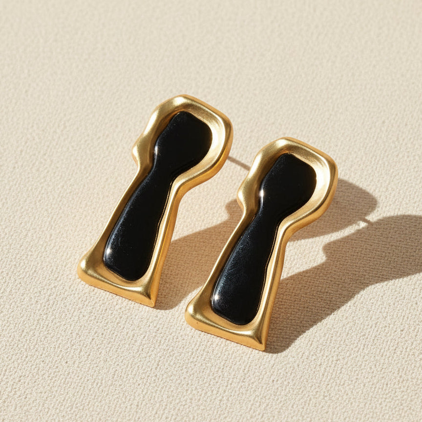 The Secret Keyhole surrealist earrings lifestyle styled shot, black enamel and gold plated brass by The Civilis