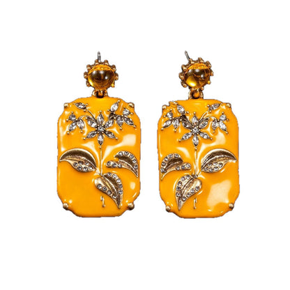 Yellow earrings on white background, full view