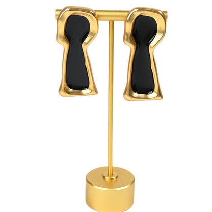 The Secret Keyhole surrealist black enamel and 18K gold plated brass earrings, full product view on white background

