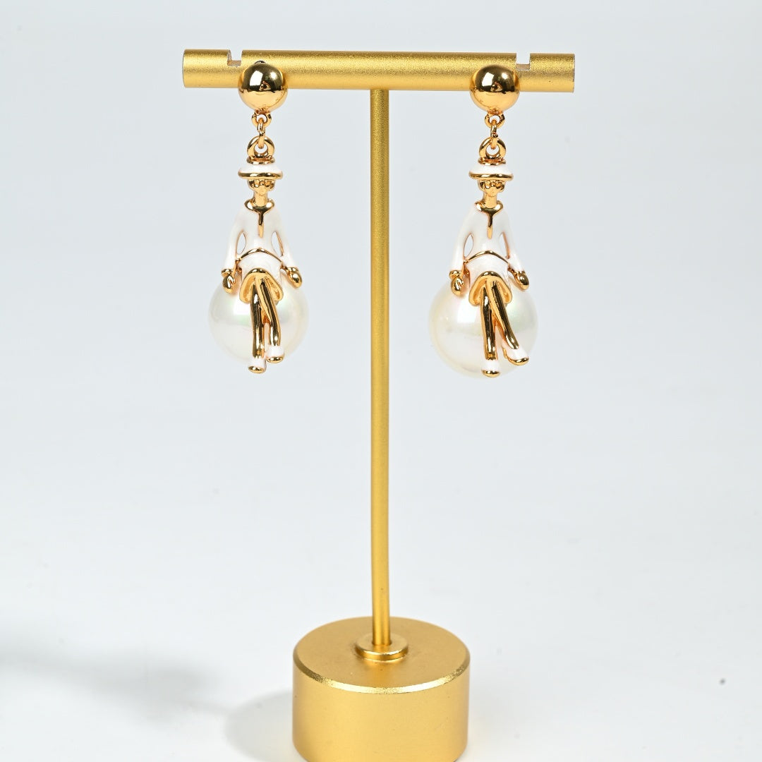 Whimsical ballerina charm earring detail showing delicate figural design and lustrous pearl drop accent