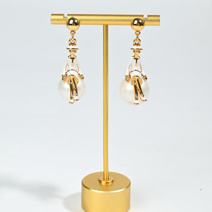 Whimsical ballerina charm earring detail showing delicate figural design and lustrous pearl drop accent