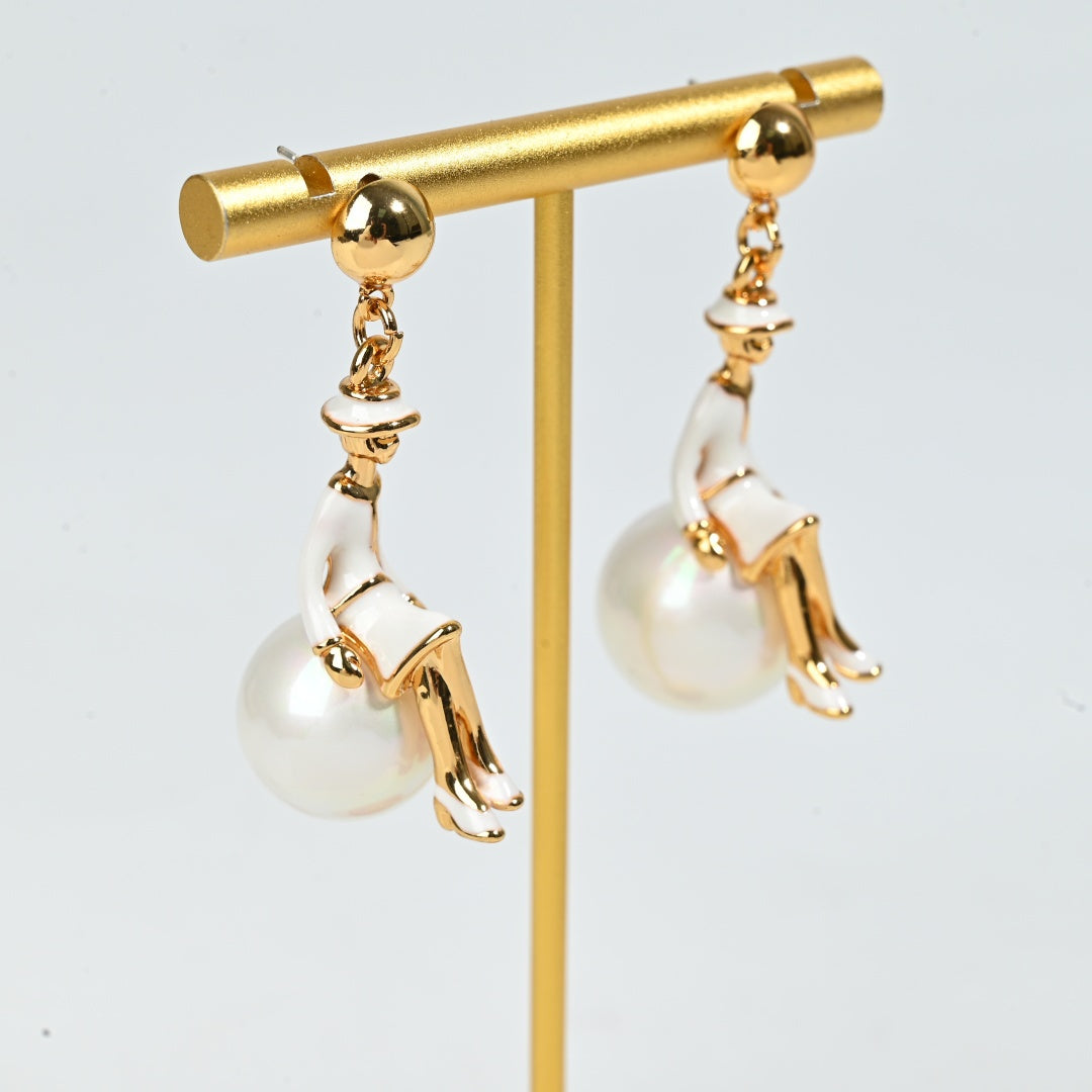 French vintage inspired ballerina earring styled detail shot, gold plated figural charm with pearl pendant