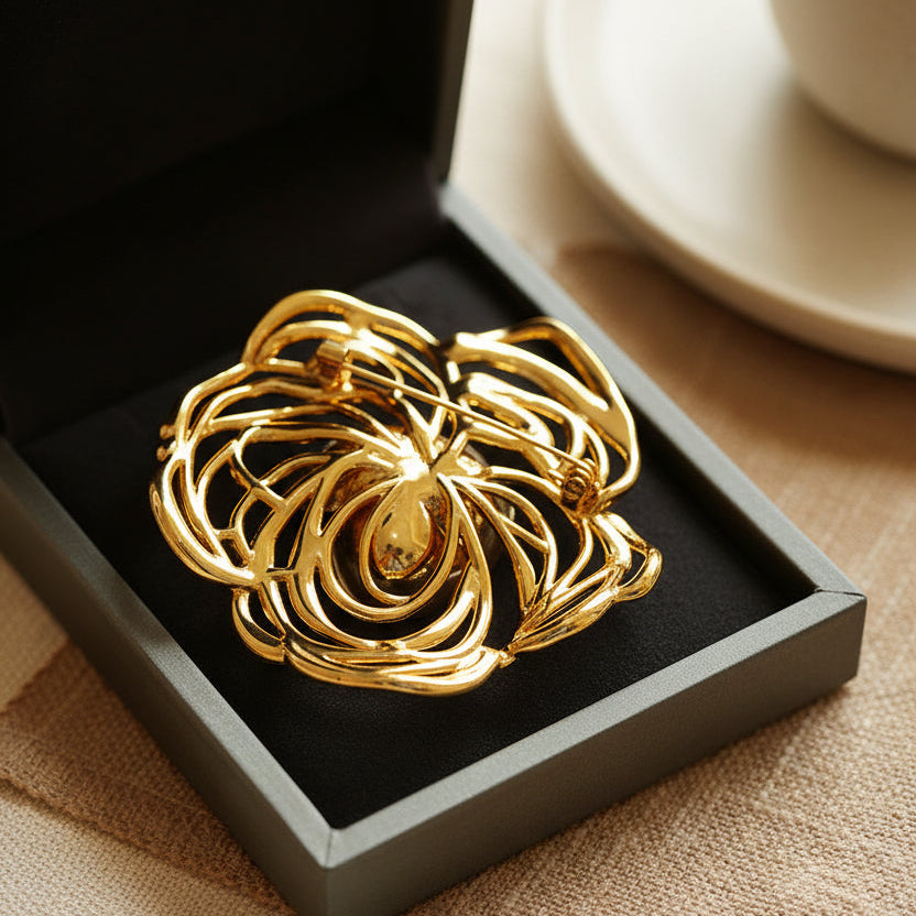 Luxury jewelry gift box featuring a gold camellia brooch for anniversary or birthday.