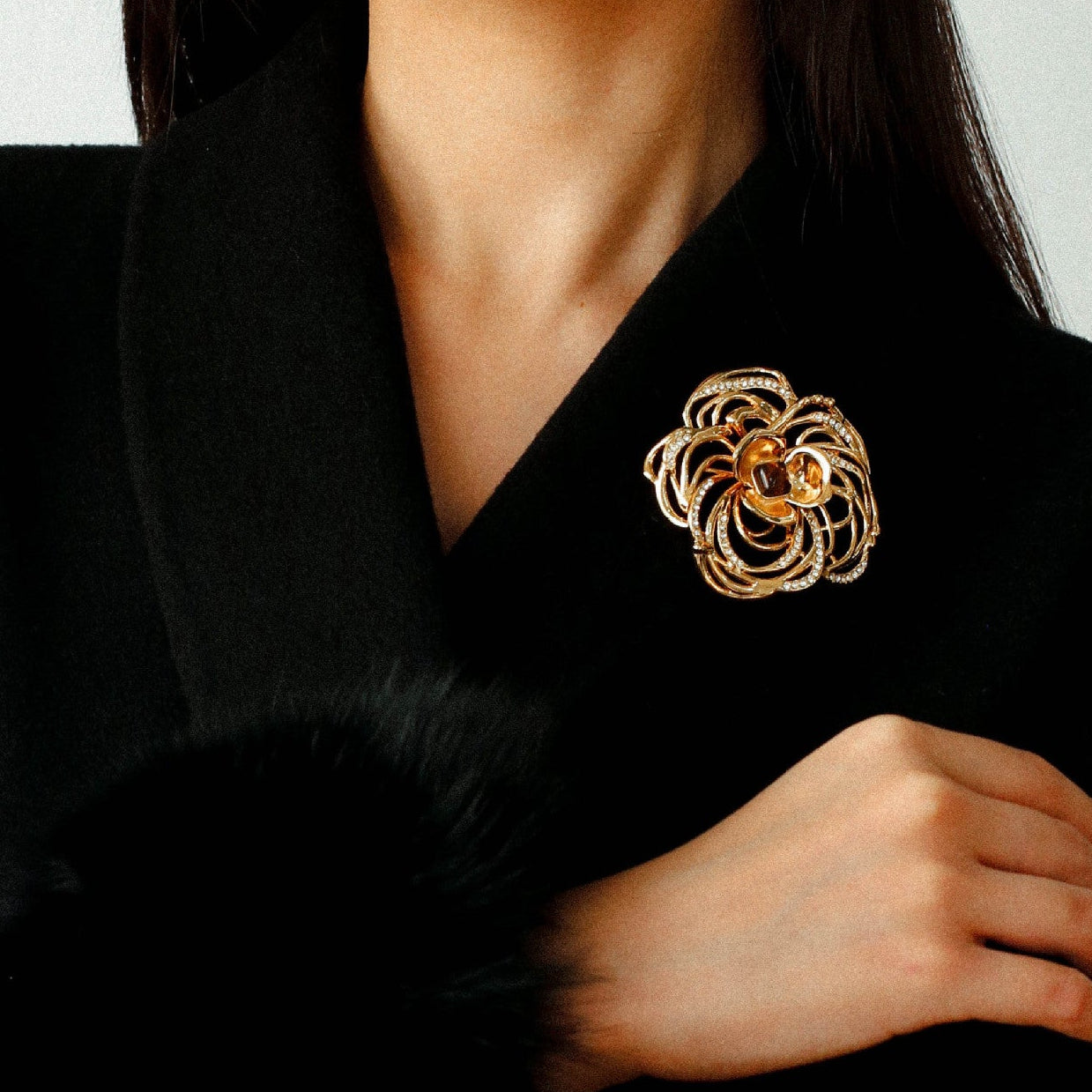 Luxury jewelry gift box featuring a gold camellia brooch for anniversary or birthday.