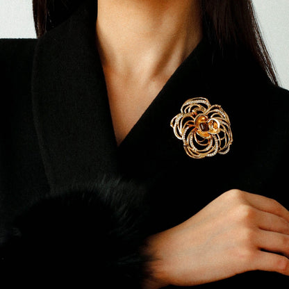 Luxury jewelry gift box featuring a gold camellia brooch for anniversary or birthday.