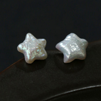 Celestial star-shaped baroque freshwater pearl stud earrings in silver, minimalist dainty jewelry for women, flat lay product photo
