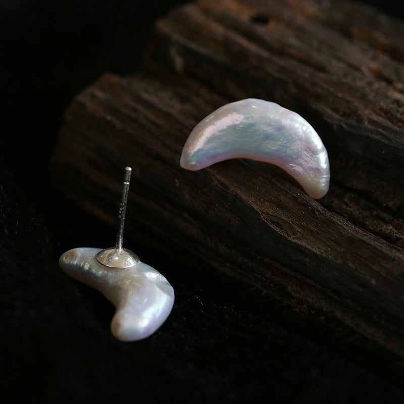 Crescent moon baroque freshwater pearl stud earrings in S925 silver, iridescent natural pearl, minimalist celestial jewelry, product flat lay