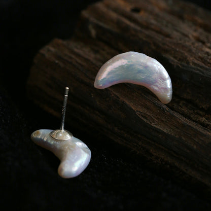 Crescent moon baroque freshwater pearl stud earrings in S925 silver, iridescent natural pearl, minimalist celestial jewelry, product flat lay