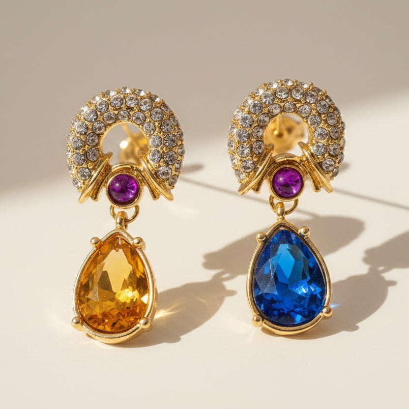Close-up detail of Dreamcatcher teardrop crystal earrings, multi-color mosaic crystals with cascading fringe, 18K gold finish