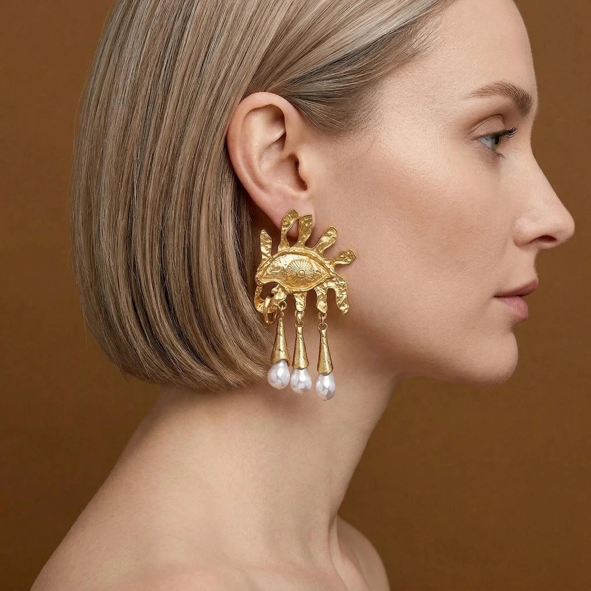 Model wearing Pegasus Winged Horse earrings, gold mythology jewelry, celestial drop studs