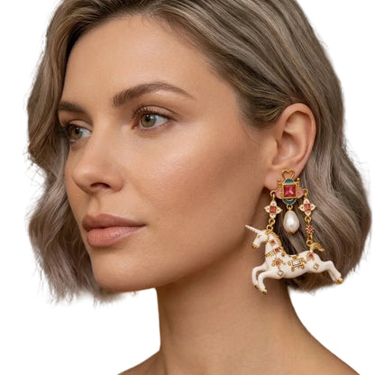 Surrealist unicorn statement earrings on model, showing full length drop