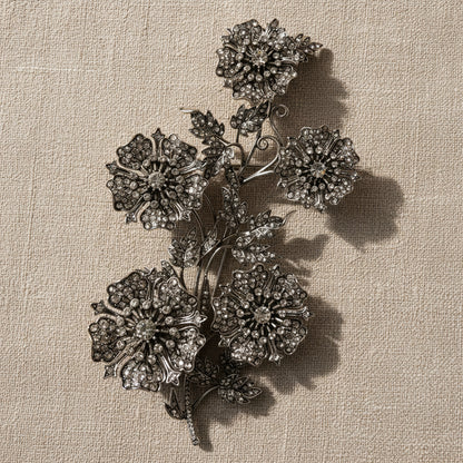 Detailed Close-up of Silver Floral Corsage with Dramatic Shadows on Natural Linen.