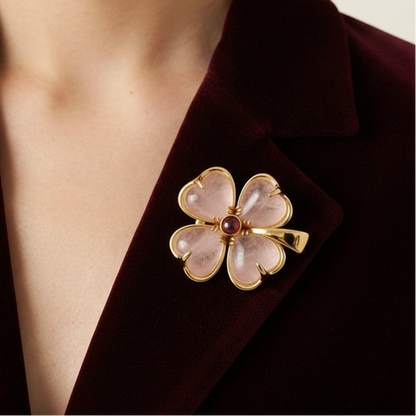 Elegant gold and white stone floral brooch pinned on a luxury dark burgundy velvet blazer, showcasing its sophisticated contrast and high-end fashion appeal.