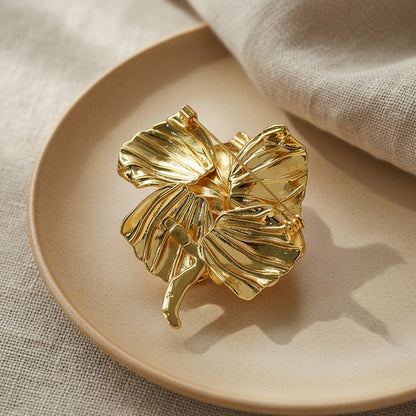 High-end designer inspired gold flower pin for wedding or formal events.