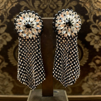 Close-up detail of Midnight Dahlia earring showing crystal dahlia flower motif and gold mesh texture
