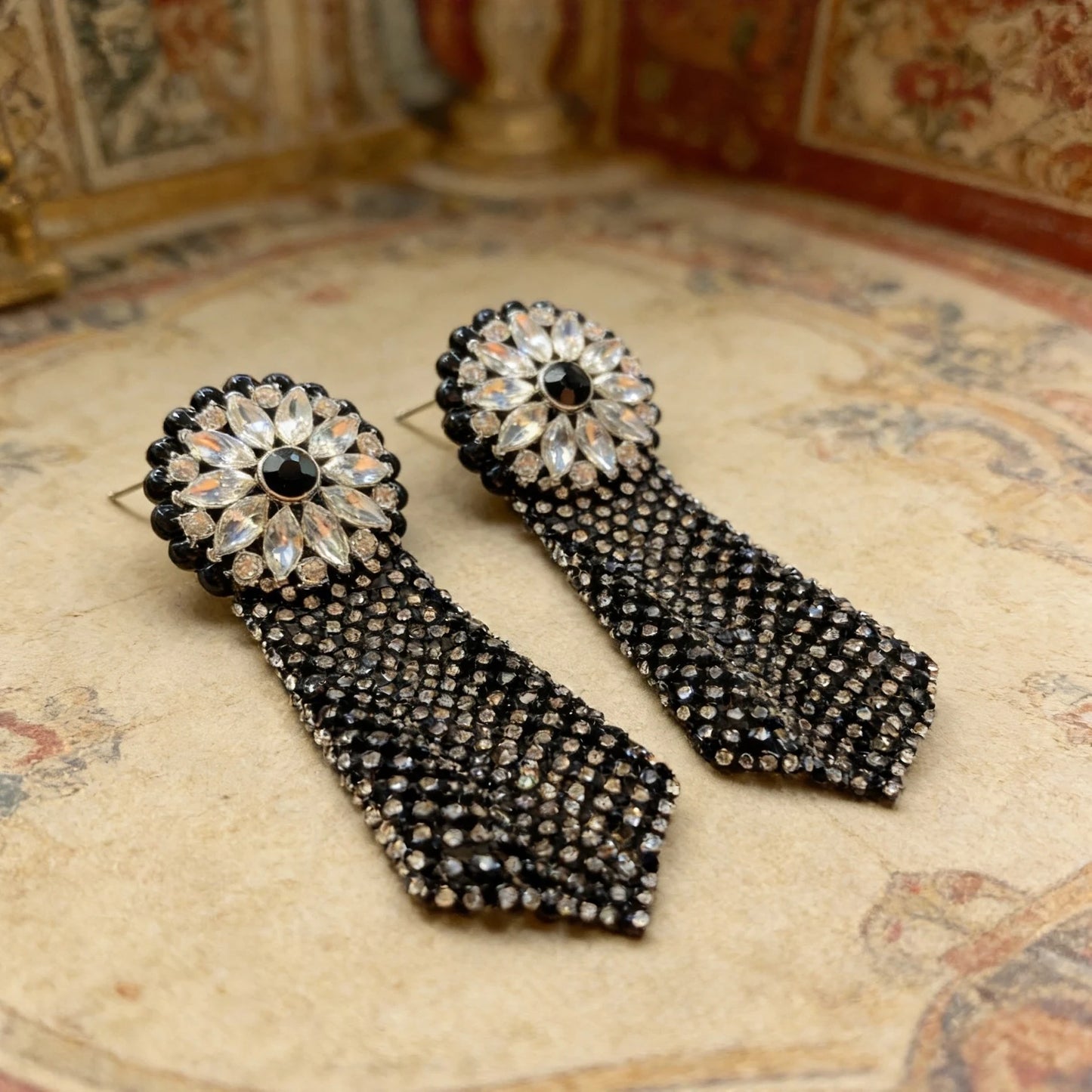 Macro detail of Midnight Dahlia mesh drop earring highlighting crystal embellishments and tassel fringe