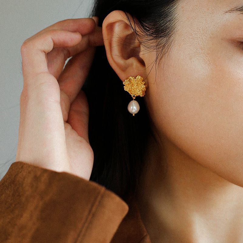 Model wearing single baroque pearl drop earring in 18K gold-plated lava texture, minimalist everyday style