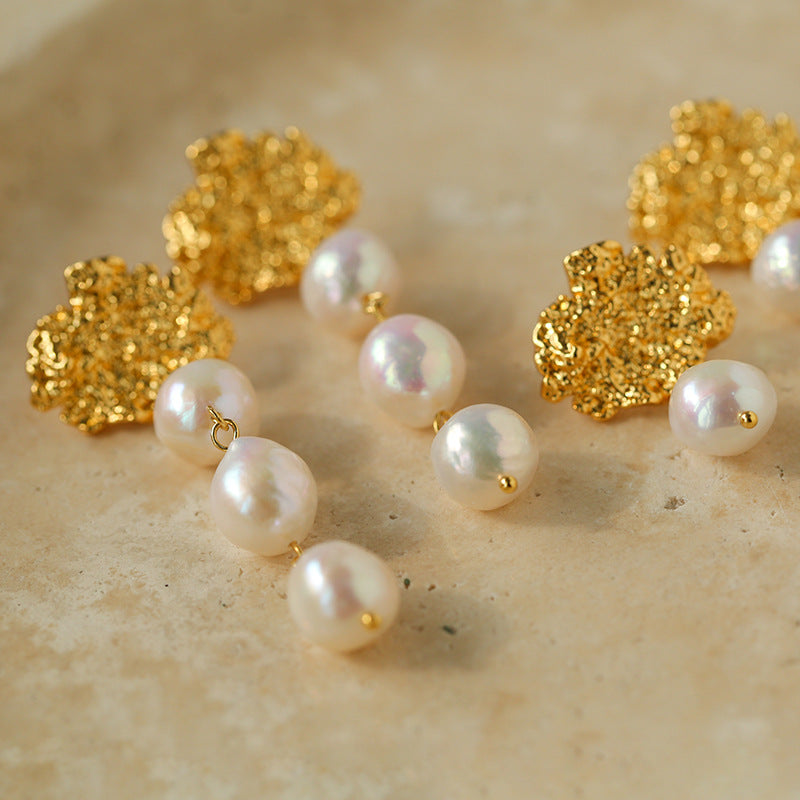Close-up of natural freshwater baroque pearl andnull18K gold-plated lava texture surface on drop earring