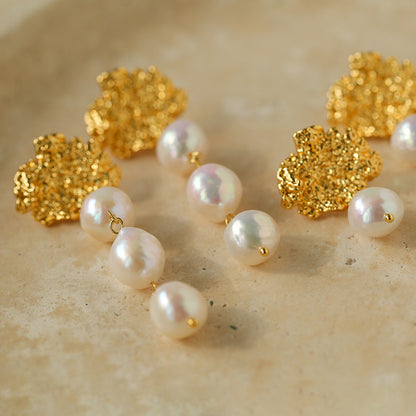 Close-up of natural freshwater baroque pearl andnull18K gold-plated lava texture surface on drop earring