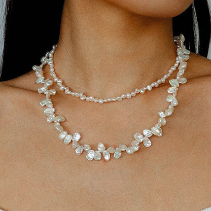 Front view of the layered baroque pearl necklace on a model, illustrating its perfect length and how it complements a summer or resort outfit.