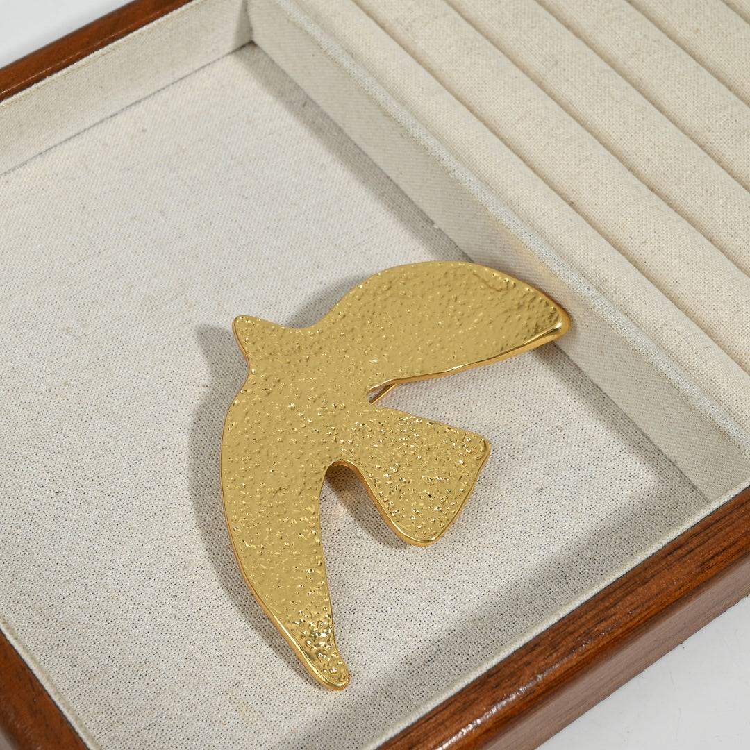Front view of Golden Echoes 18K gold plated peace dove brooch with hammered texture and Forever engraving detail