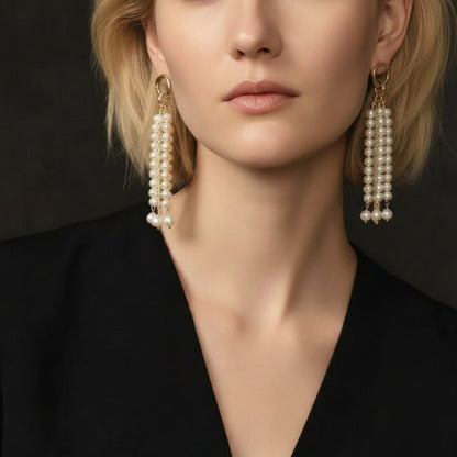 High-contrast shot of the statement pearl earrings paired with a black blazer, showcasing a sophisticated and powerful professional look.