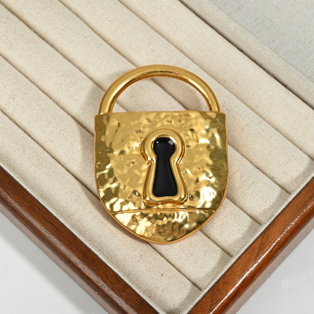 Surrealist gold lock brooch lifestyle styled shot, 18K gold plated brass statement piece by The Civilis