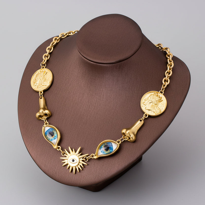 Surrealist Eye & Sun Medallion Necklace displayed on mannequin, vintage gold tone