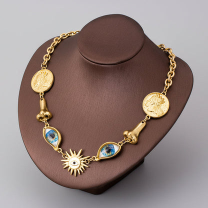 Surrealist Eye & Sun Medallion Necklace displayed on mannequin, vintage gold tone