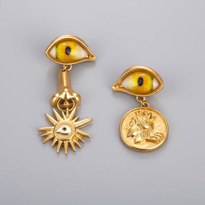 Surrealist Eye & Sun Medallion Earrings full view, vintage gold tone
