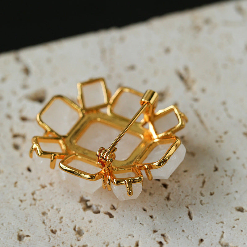 Close-up of 18k gold plated brass backing for crystal brooch, premium quality craftsmanship in fine costume jewelry.