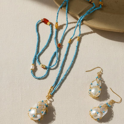 Artisan baroque pearl and turquoise jewelry set full view on beige background 18K gold plated boho chic statement jewelry

