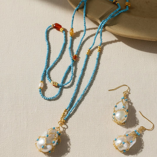 Artisan baroque pearl and turquoise jewelry set full view on beige background 18K gold plated boho chic statement jewelry

