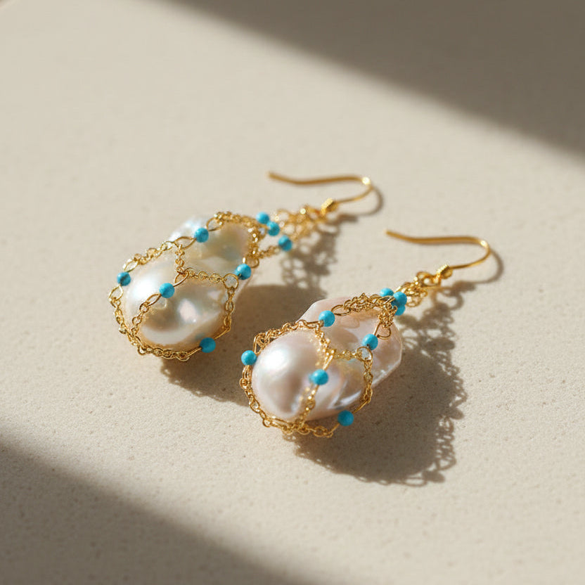  Close-up detail of baroque pearl and stabilized turquoise drop earrings 18K gold plated brass boho statement jewelry

