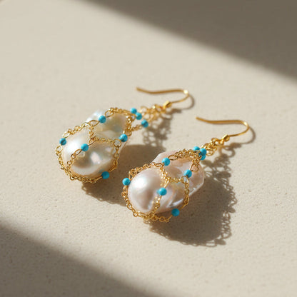  Close-up detail of baroque pearl and stabilized turquoise drop earrings 18K gold plated brass boho statement jewelry

