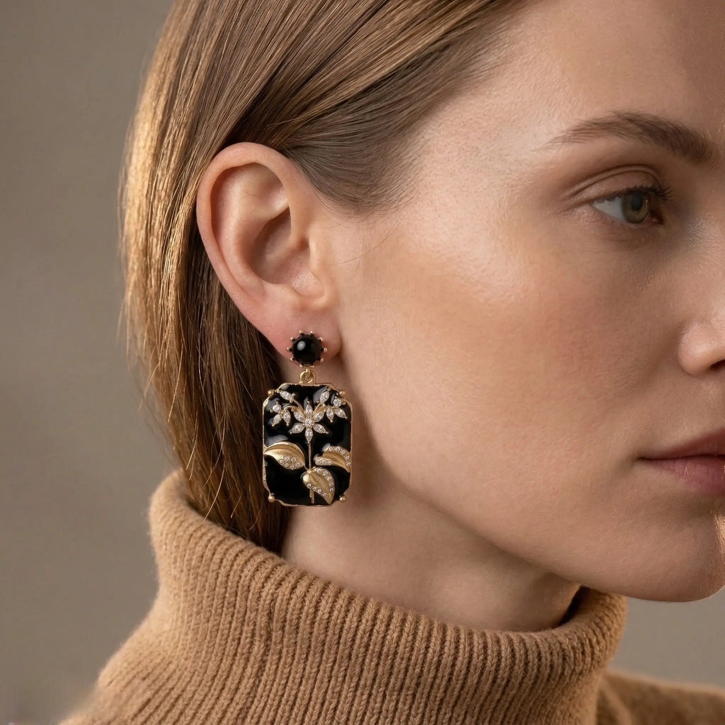 Black Enamel Floral Stud Earrings worn on model, ear styling shot