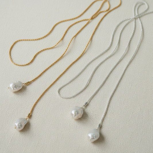  Long baroque pearl lariat necklace gold and silver versions full view on beige linen background 18K gold plated twisted rope chain

