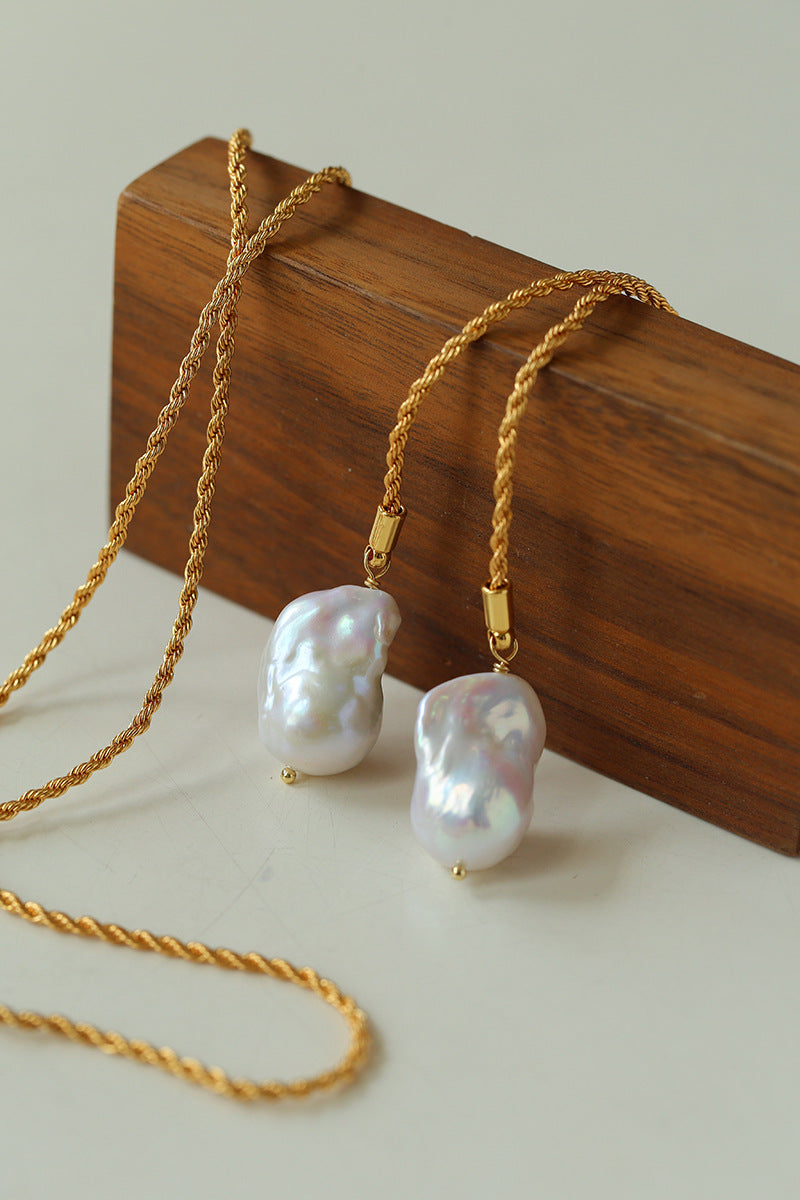 Close-up detail of gold baroque pearl lariat necklace 18K gold plated twisted rope chain pearl pendant