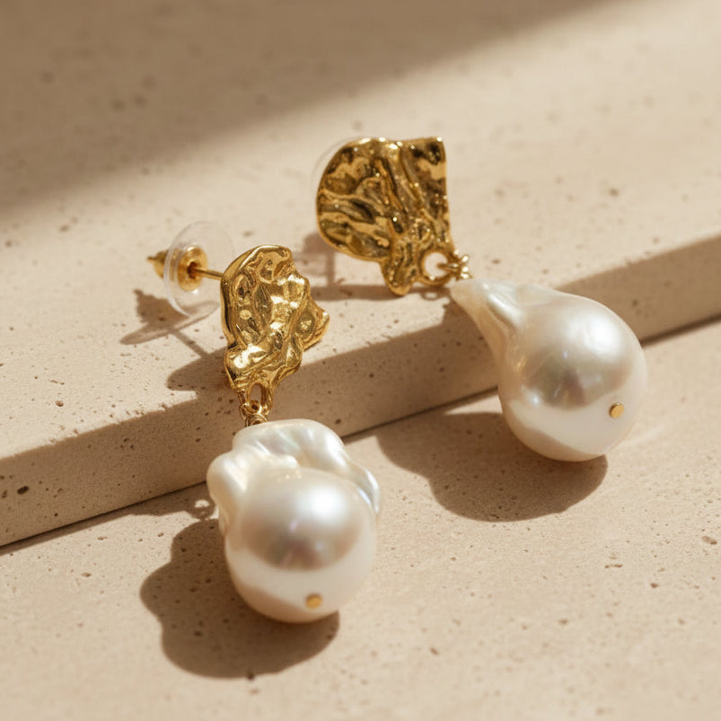 Molten gold baroque pearl drop earrings full view on soft beige stone background 18K gold plated surrealist statement jewelry

