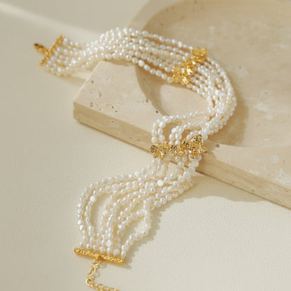 Multi-strand mini freshwater pearl choker full view on beige background 18K gold plated brass vintage layered statement necklace