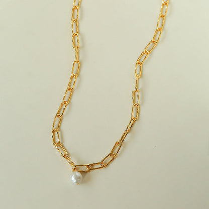 18K gold plated paperclip chain necklace with baroque pearl pendant full view on beige background minimalist chunky link choker

