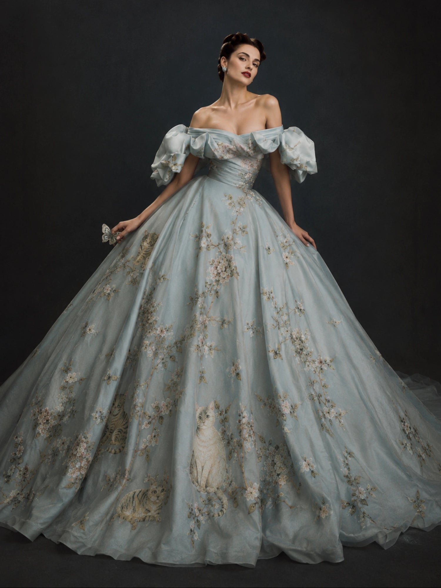 A stunning custom-made powder blue haute couture ballgown by The Civilis, featuring romantic off-the-shoulder puff sleeves, a ruched bodice, and a voluminous dramatic skirt embellished with intricate silver and gold heritage embroidery.